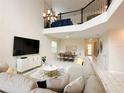 Open-concept home featuring high ceilings, a spacious seating area, and a combined dining area with ample natural light at 671 Drop Shot Dr, Davenport, FL 33896