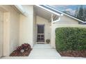 Inviting entryway with a decorative front door, potted plants, and neatly trimmed landscaping at 708 Wilson Rd, Winter Springs, FL 32708