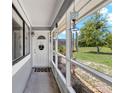 Front porch featuring a welcome mat, a white trimmed screen, and a decorative hanging wind chime at 722 Ridgewood Way, Winter Springs, FL 32708
