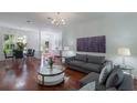 Bright, open-concept living area with hardwood floors and elegant furnishings at 920 Cool Springs Cir, Ocoee, FL 34761