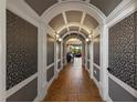 Elegant hallway features decorative wall panels, a beautiful archway, and tile flooring at 970 Golden Bear Dr, Reunion, FL 34747