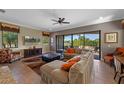 Comfortable living room with a ceiling fan, tile floors, and sliding glass doors to the patio at 970 Golden Bear Dr, Reunion, FL 34747