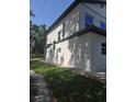 Modern house displays sleek architecture with neutral tones and a neatly kept lawn and landscaping at 1005 Randall St, Orlando, FL 32805