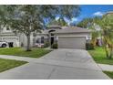Charming single-Gathering home with a well-maintained lawn, stone accents, and a two-car garage at 10293 Cypress Knee Cir, Orlando, FL 32825