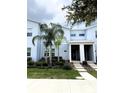 Stylish townhome with a modern exterior, landscaped front yard, and a covered entryway at 1078 Splash Shot Pl, Davenport, FL 33896