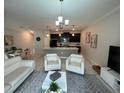 Inviting living area featuring modern decor, tile flooring, and seamless flow to the kitchen at 1078 Splash Shot Pl, Davenport, FL 33896