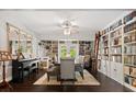 Elegant dining room with built-in bookshelves, chandelier, and a grand piano creates a sophisticated ambiance at 110 S Edgemon Ave, Winter Springs, FL 32708