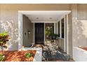 Inviting front porch featuring a black front door, wood decking, and stylish architectural details at 110 S Edgemon Ave, Winter Springs, FL 32708