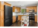 Well-equipped kitchen with wood cabinets, stainless steel appliances, and plenty of counter space at 110 S Edgemon Ave, Winter Springs, FL 32708