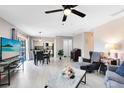 Bright living room with luxury vinyl plank flooring, ceiling fan, and access to kitchen at 117 Georgetown Dr # C, Casselberry, FL 32707