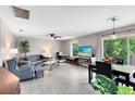Inviting living room with lots of natural light, neutral paint, and sliding doors to the balcony at 117 Georgetown Dr # C, Casselberry, FL 32707