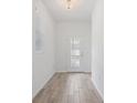 Bright entryway with wood-look tile flooring, a modern light fixture, and a glass-paneled front door at 12009 Walmsley Aly, Winter Garden, FL 34787