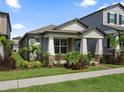Attractive home featuring a covered entryway, well-kept lawn, and tasteful landscaping at 12009 Walmsley Aly, Winter Garden, FL 34787