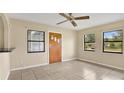 Open floor plan, tile flooring, and natural light, with view of kitchen at 1202 Randolph St, Sanford, FL 32771