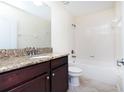 Bathroom featuring granite countertops, a modern vanity, and a shower-tub combination with tiled walls at 1748 Thetford Cir, Orlando, FL 32824