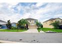 Pleasant home exterior boasting a well-kept lawn, mature trees, and an ample driveway leading to a two-car garage at 1748 Thetford Cir, Orlando, FL 32824