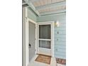 Inviting entrance with a charming doormat, a secure digital lock, and a well-lit porch creating a warm welcome at 2020 Royal Bay Blvd # 91, Kissimmee, FL 34746