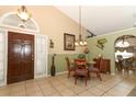 Dining area with a glass-top table and views into living room at 2021 Wildfire Ct, Apopka, FL 32703