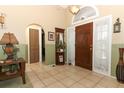 Welcoming foyer with tile flooring and a decorative mirror and table at 2021 Wildfire Ct, Apopka, FL 32703