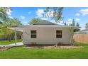 Bright exterior of a well-maintained single-story home with a lush lawn at 215 Bradbury Ave, Oak Hill, FL 32759