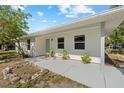 Cozy covered porch with plants, offering a welcoming entrance to the home at 215 Bradbury Ave, Oak Hill, FL 32759
