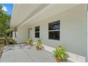 Inviting covered porch featuring potted plants, enhancing curb appeal at 215 Bradbury Ave, Oak Hill, FL 32759