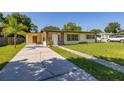 Inviting single-story home with a spacious driveway and lush green lawn at 2222 Catherine St, Kissimmee, FL 34741