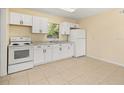 Bright kitchen with white cabinets, granite countertops, and modern appliances at 2222 Catherine St, Kissimmee, FL 34741