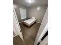 A basic bedroom with a single bed and window at 2236 Stonington Ave # 2236, Orlando, FL 32817