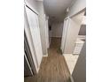 Hallway with wooden floors, white closets, and a view into other rooms at 2236 Stonington Ave # 2236, Orlando, FL 32817