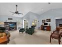 Bright living room featuring vaulted ceilings, lots of natural light, comfortable seating, and a ceiling fan at 2344 Whispering Maple Dr., Orlando, FL 32837