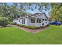 Well-maintained house with a cute front porch, landscaping, and a driveway at 2401 Mayer St, Orlando, FL 32806