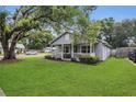 A cozy home featuring a quaint front porch and lush green lawn at 2401 Mayer St, Orlando, FL 32806