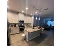 Open kitchen featuring stainless steel appliances and a center island at 2937 Econ Landing Blvd, Orlando, FL 32825