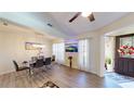 Dining room featuring a chandelier, a TV on the wall, and wood flooring at 3044 Camino Real S Dr, Kissimmee, FL 34744