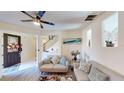 Bright living room featuring modern sofas, recessed shelving and an open entry way at 3044 Camino Real S Dr, Kissimmee, FL 34744