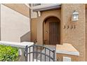 Charming front entrance with dark wood door, arched entryway, and decorative exterior lighting at 3331 Windsor Lake Cir, Sanford, FL 32773