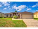 Charming single-Gathering home with manicured lawn and attached two-car garage on a sunny day at 351 Cloverdale Rd, Winter Haven, FL 33884