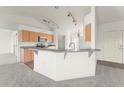 Bright kitchen features stainless steel appliances, tiled floors and breakfast bar at 351 Cloverdale Rd, Winter Haven, FL 33884