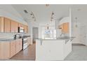 Bright kitchen features stainless steel appliances, tiled floors and breakfast bar at 351 Cloverdale Rd, Winter Haven, FL 33884