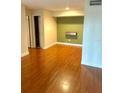 Spacious living room with hardwood floors and a modern accent wall at 3772 Idlebrook Cir # 100, Casselberry, FL 32707