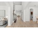 Bright and airy foyer with high ceilings, wood floors, and staircase leading to the second floor at 3868 Whitewood Ct, Oviedo, FL 32766
