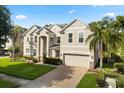Attractive two-story home with a two-car garage, brick driveway, and well-kept landscaping at 3868 Whitewood Ct, Oviedo, FL 32766