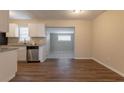 Bright kitchen features granite countertops, stainless steel appliances, new cabinets, and modern flooring at 4267 Kirkland Blvd, Orlando, FL 32811