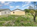 This view of a backyard shows the yard with a building in the background at 450 S Buena Vista Ave, Orlando, FL 32835
