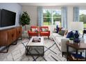 Inviting living room featuring a neutral color palette, modern furnishings, and plenty of natural light at 4543 Windy Oak Way, St Cloud, FL 34772