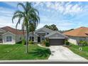 Charming one-story home boasts a manicured lawn, a two car garage, and beautiful landscaping at 468 Jaybee Ave, Davenport, FL 33897