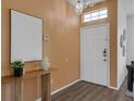Bright foyer featuring modern decor, attractive laminate flooring, and a convenient security system at 468 Jaybee Ave, Davenport, FL 33897