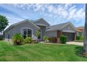 Charming one-story home boasts a manicured lawn, a two car garage, and beautiful landscaping at 468 Jaybee Ave, Davenport, FL 33897