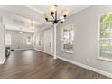 Inviting foyer with white columns, wood-look floors, and ample natural light at 5032 Beach River Rd, Windermere, FL 34786
